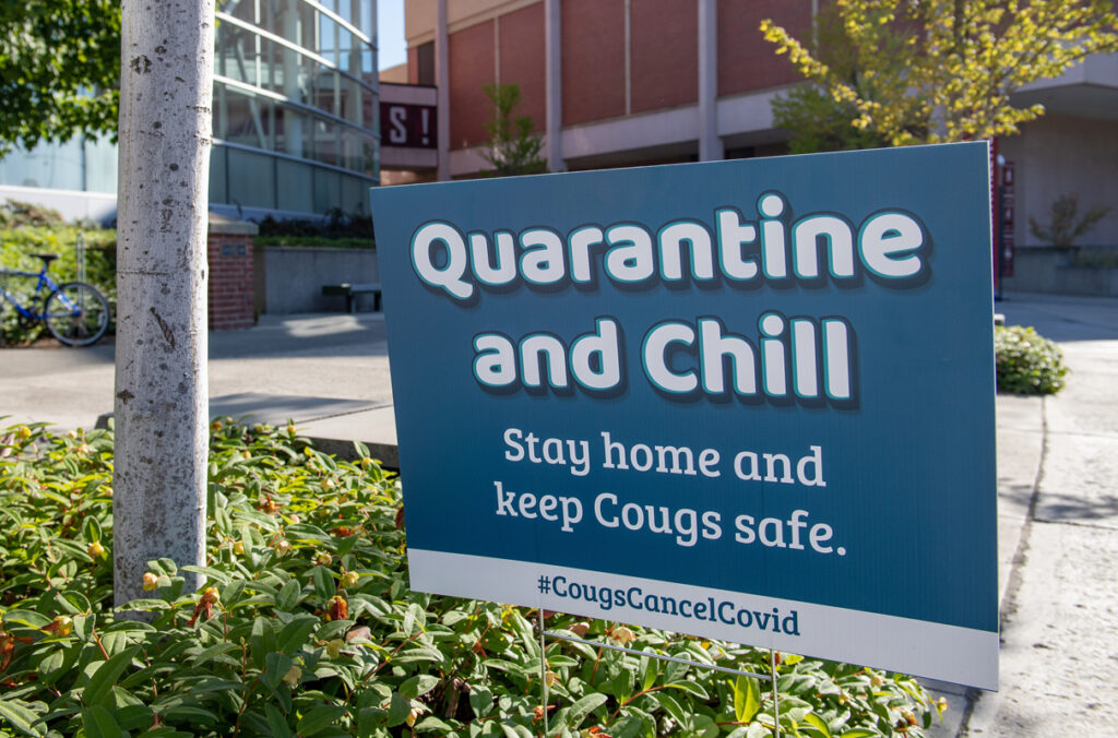 A sign reads "Quarantine and chill. Stay home and keep Cougs safe." on the WSU Pullman campus.