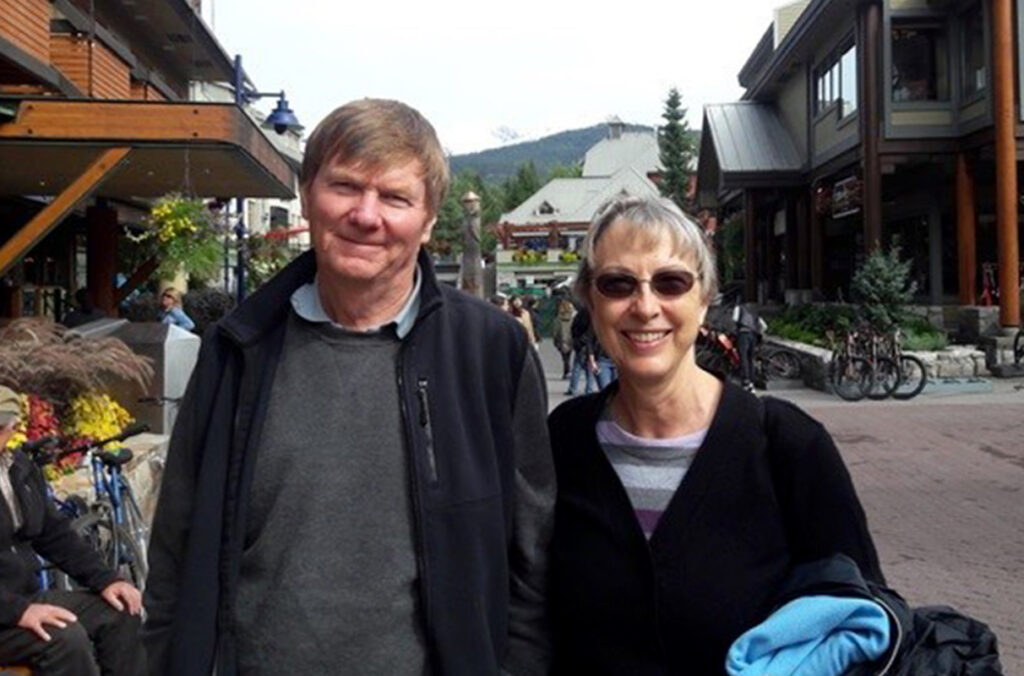 Closeup of Doctors Tony and Joy Barbet standing in a plaza.