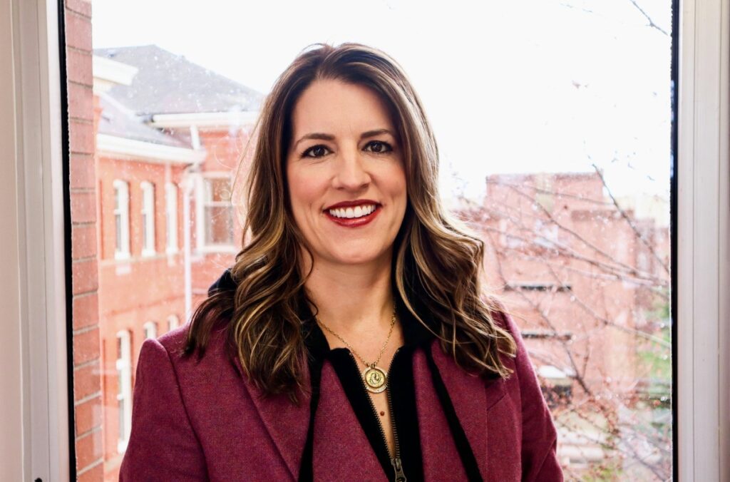 Closeup of Jennifer Henrichsen in front of window.