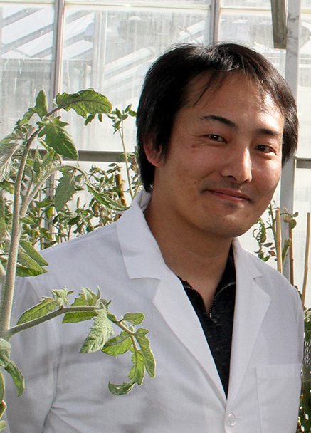 Closeup of Kiwamu Tanaka in a greenhouse.