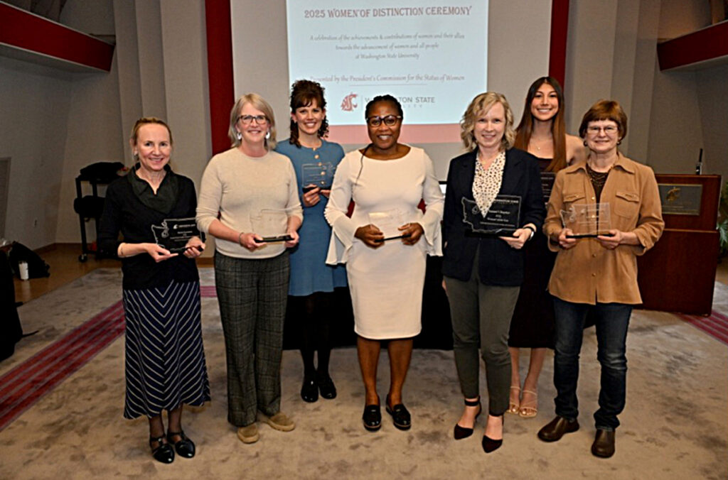 Seven 2025 Women of Distinction award winners posing with their awards.