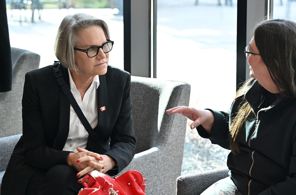 WSU President Elizabeth Cantwell sitting and listening intently to someone.