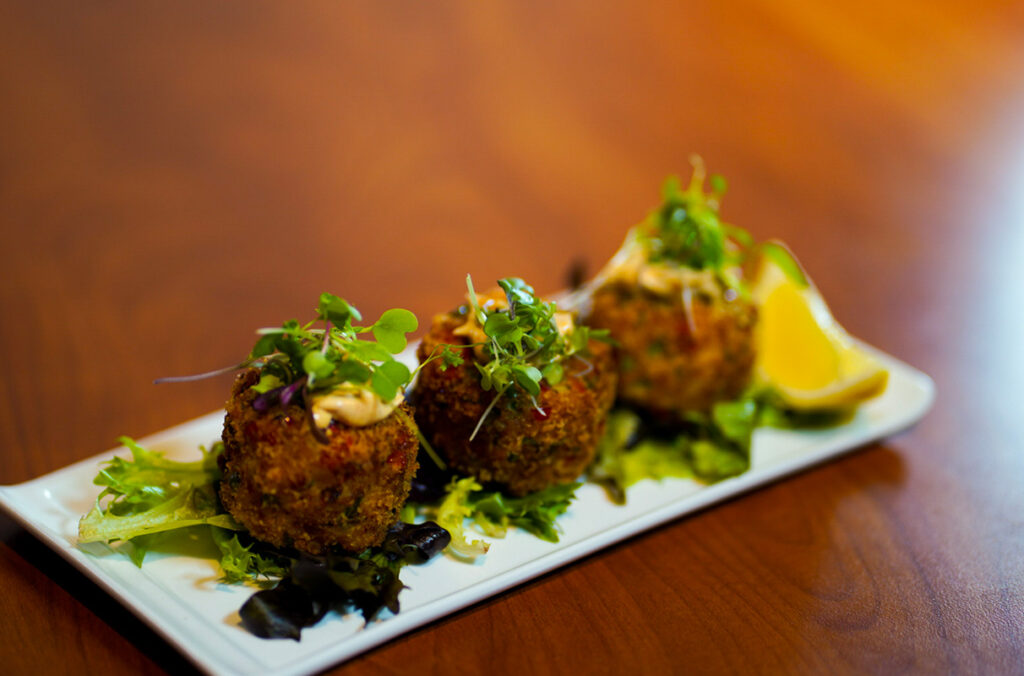 A closeup of crab cakes prepared by The Table.