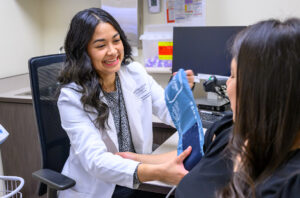 Catalina Yepez sitting in an office preparing to take a patient's blood pressure.