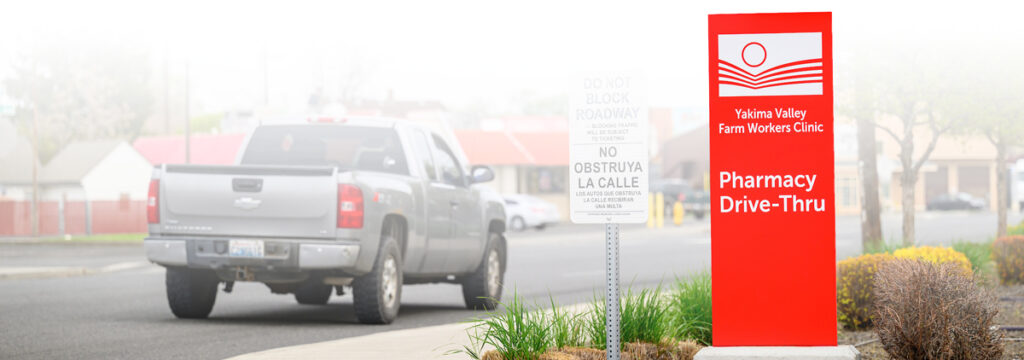 A sign for the pharmacy drive-thru outside the Yakima Valley Farm Workers Clinic.