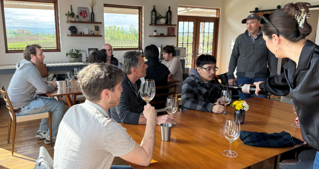 WSU V&E students receive samples of merlot inside a tasting room at Pepper Bridge Winery.