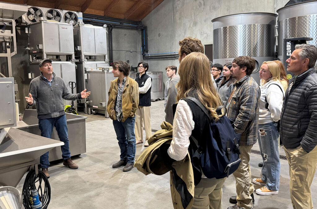 WSU V&E students listening to a tour guide in the production facilities of Pepper Bridge Winery.
