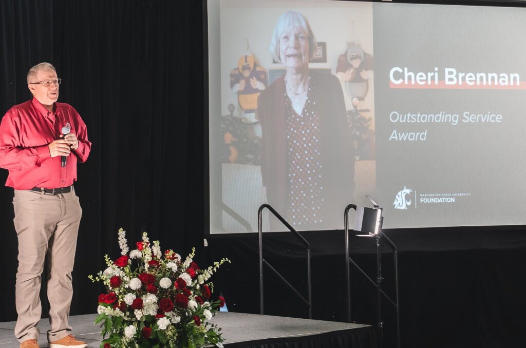 Mingé recognizes Brennan, who was unable to attend the event.