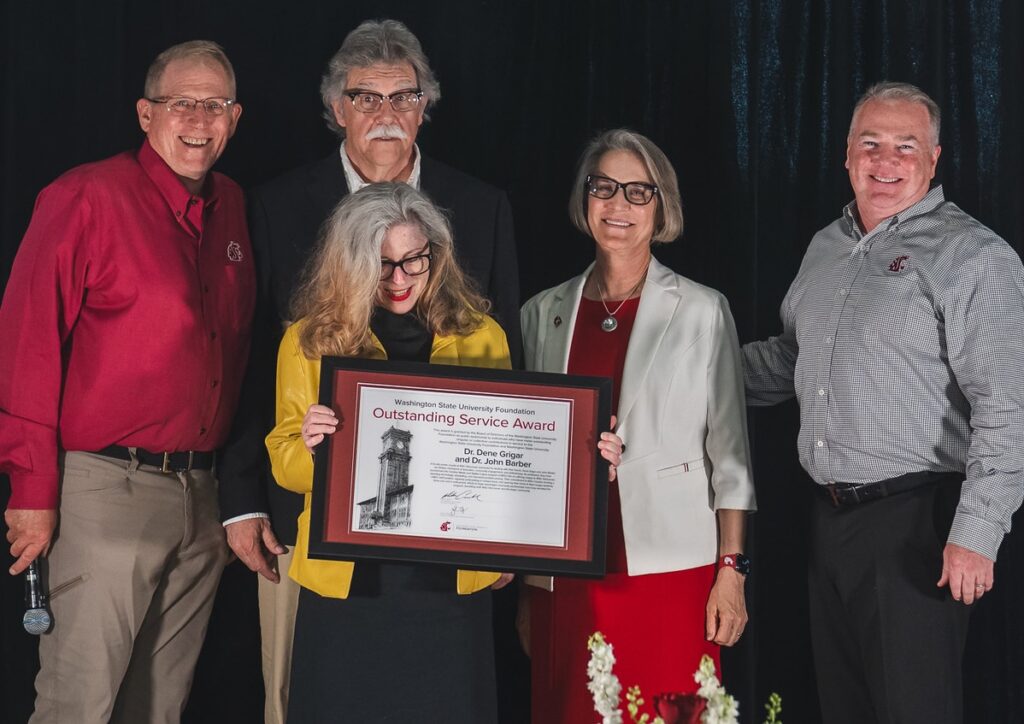 Barber and Grigar, second and third from left, receive an OSA from Mingé, left, Cantwell, second from right, and Connell, right.