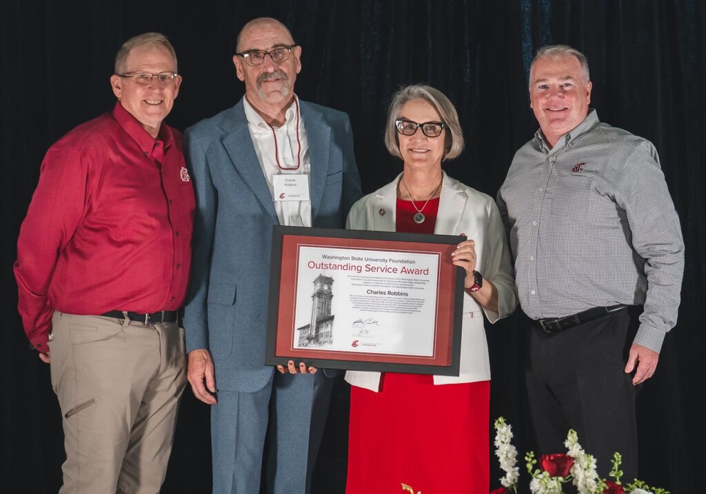 Robbins, second from left, receives an OSA from Mingé, left, Cantwell, second from right, and Connell, right.