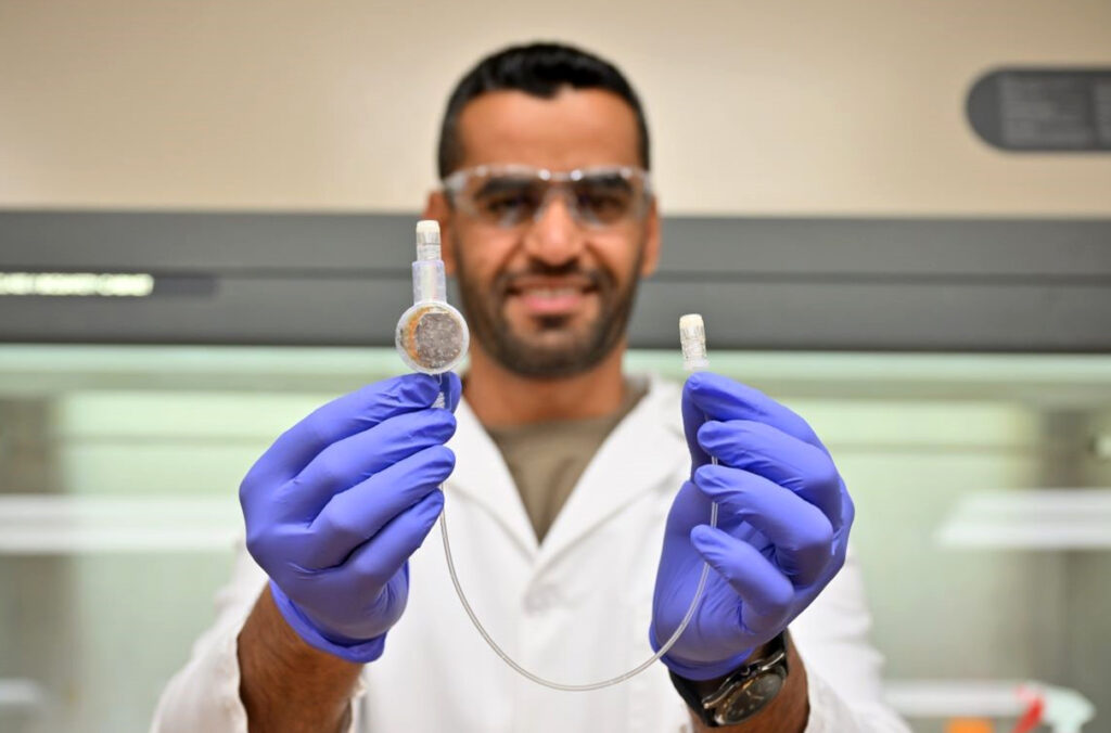 Closeup of Majid Al-qurahi holding an e-catheter.