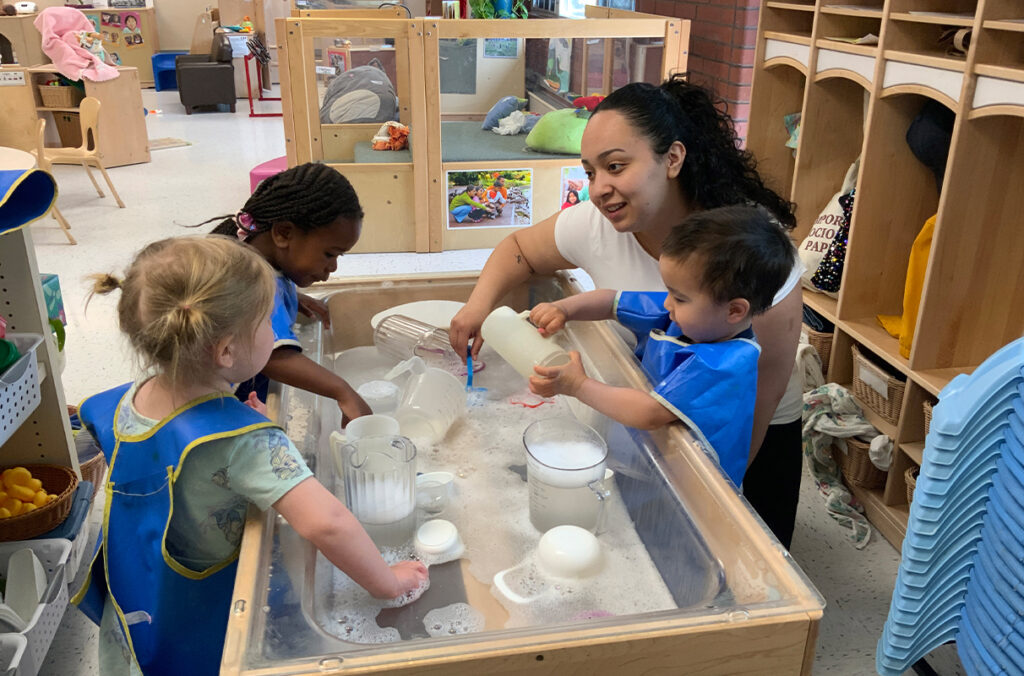 Closeup of Nele Escobar working with children at the WSU Children’s Center.