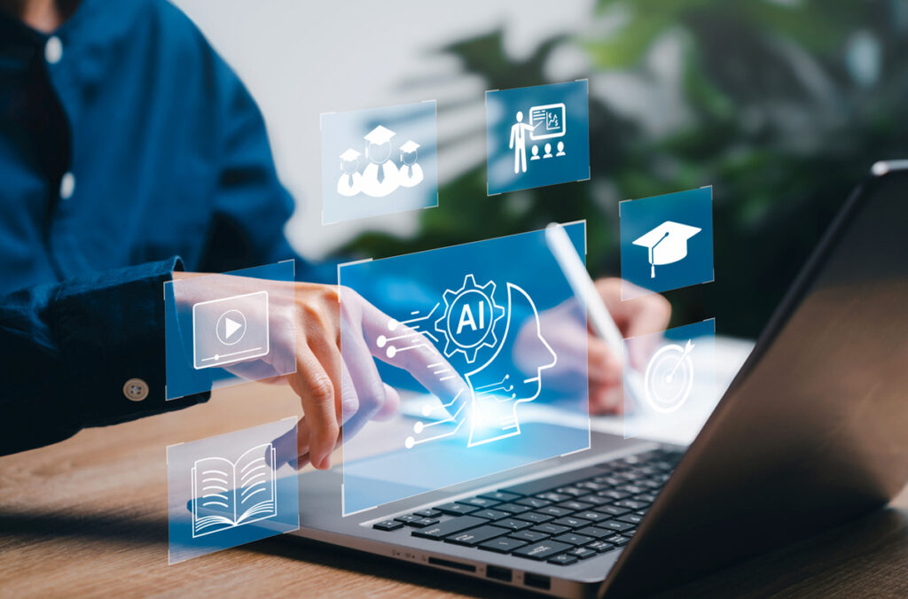 AI and other icons superimposed over a student's hands as they work at a computer.