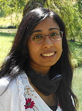 Closeup of Priya Panday-Shukla in front of a tree.