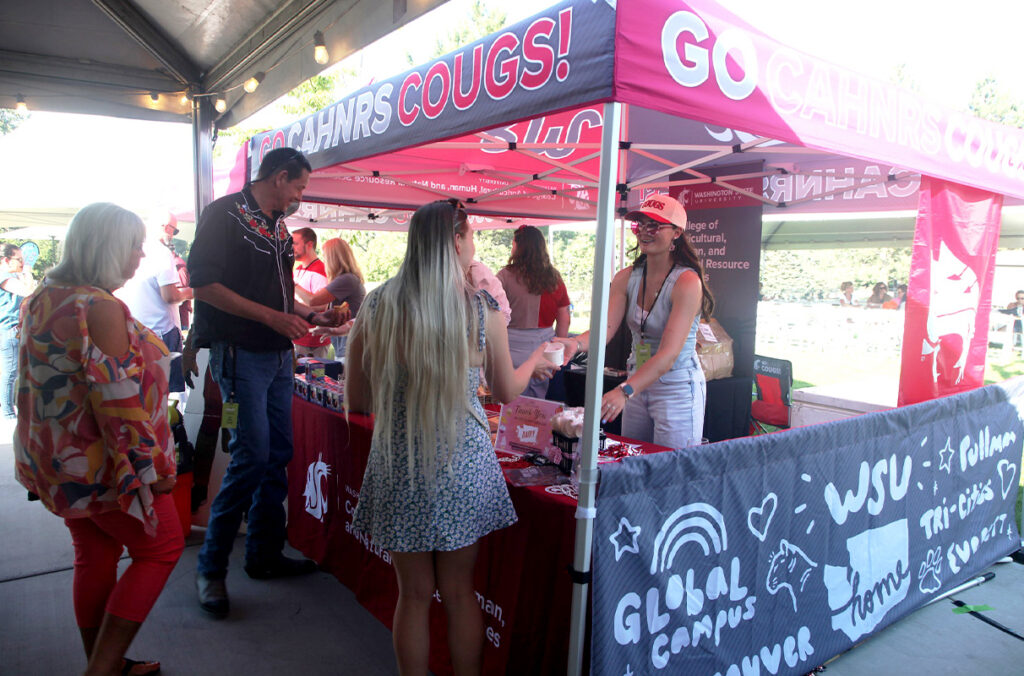 People line up to try food at a WSU-themed booth at the 2025 Crave! Northwest food festival.