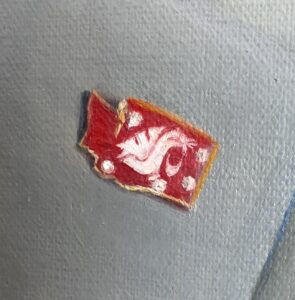 Closeup of a lapel pin on a painting of WSU President Kirk Schulz.