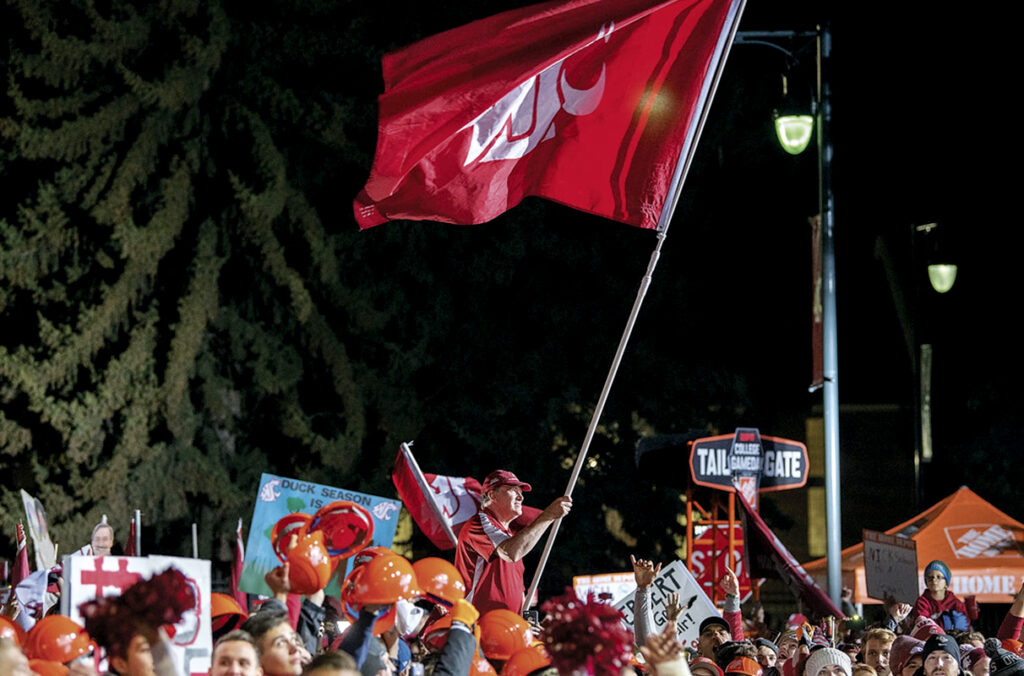 Tom Pounds waving a giant Cougar flag during filming of ESPN's College GameDay on the WSU Pullman campus.