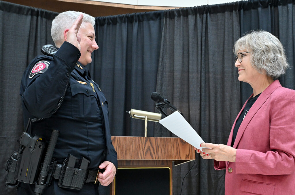 Dawn Daniels raises her right hand as President Elizabeth Cantwell swears her in as new WSU Police chief.