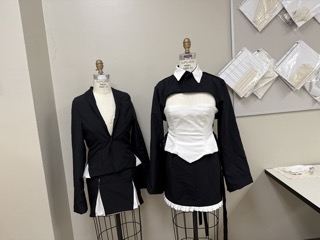 Closeup of two outfits made by Hargrove. 