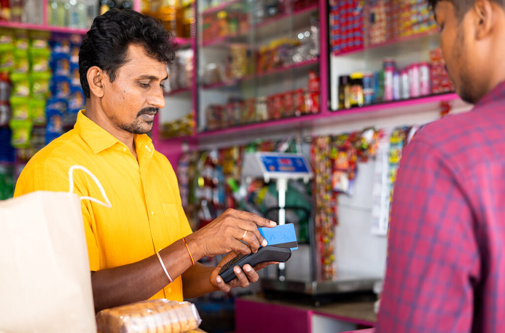 A merchant in India accepts a credit card payment from a customer.