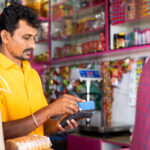 A merchant in India accepts a credit card payment from a customer.