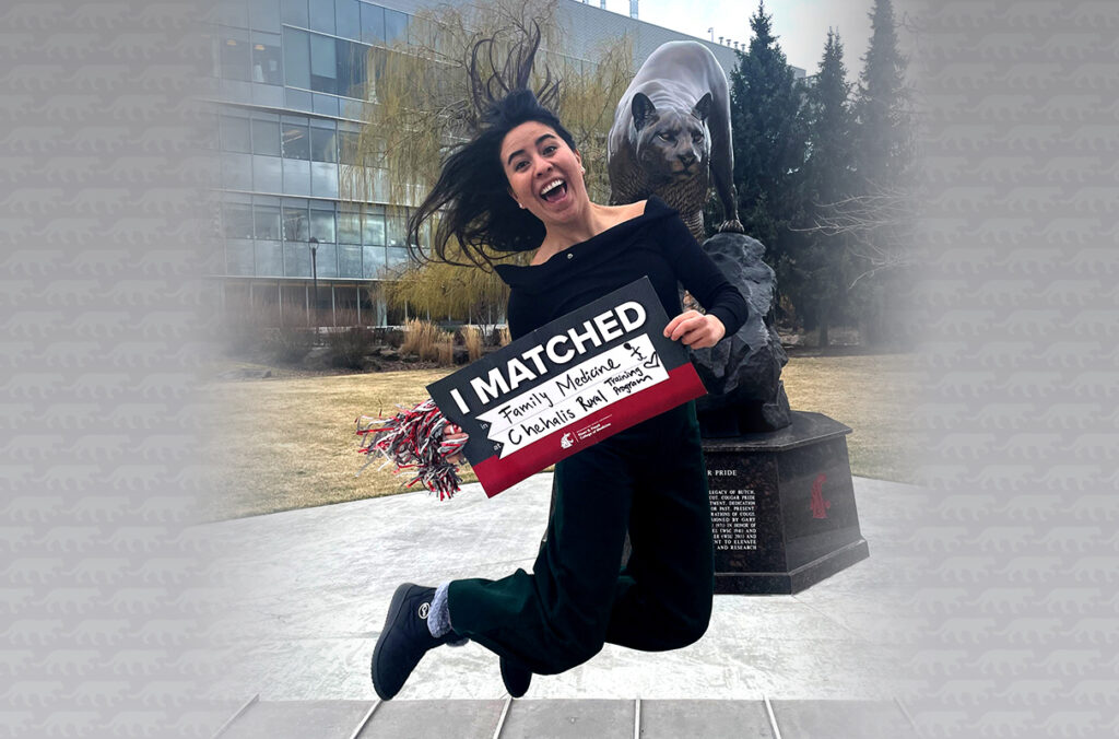 Laura Lopez jumping for joy in front of a cougar statue while holding an "I Matched" sign.
