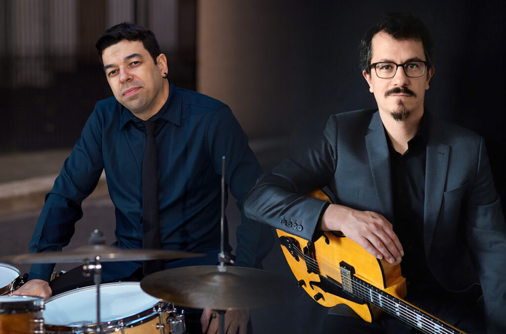 Composition featuring a closeups of Rafael Barata sitting at a drum set and César Haas holding a guitar.