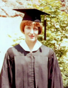Closeup of Sandra Cain in a cap and gown.