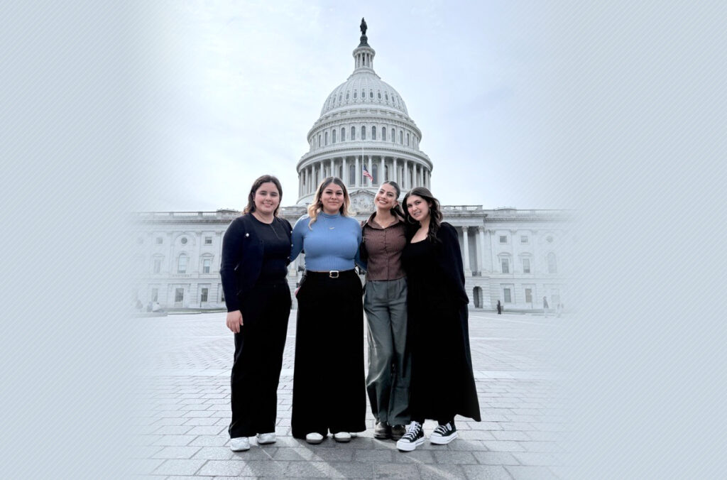 Four students standing in front of the Capitol Building in Washington, D.C.