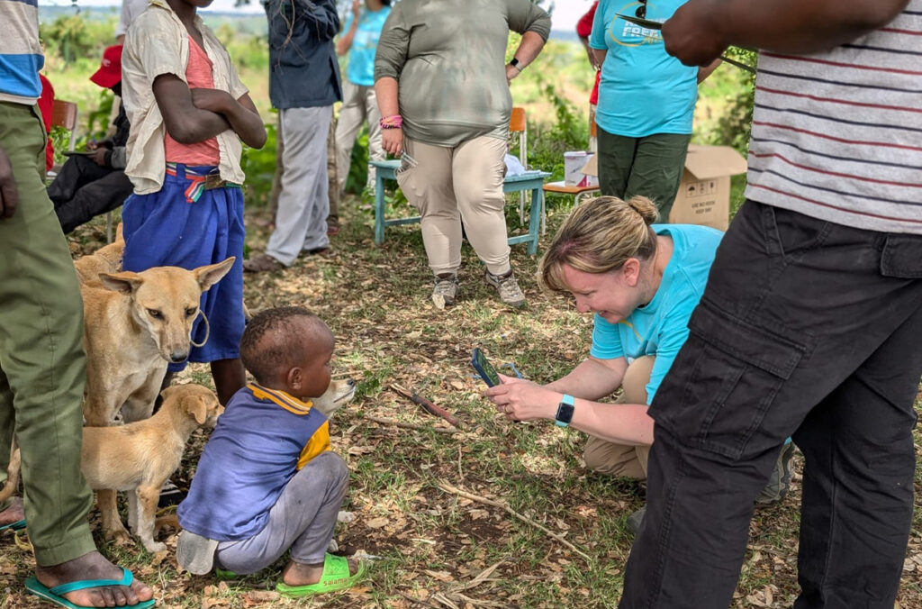 A veterinarian assisting with a mass dog vaccination in Tanzania takes a photo of a dog.