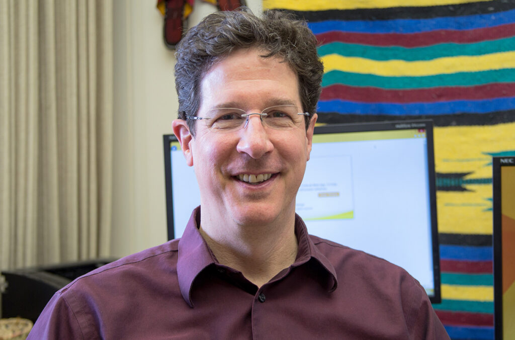 Closeup of Tom Salsbury sitting in his office.