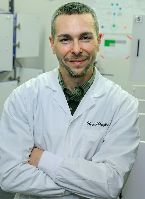 Closeup of Ryan McLaughlin in a lab coat.