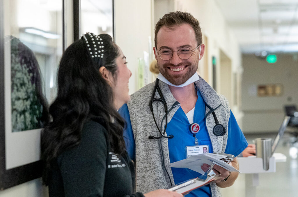 Two doctors talk in a hallway at Providence Regional Medical Center in Everett.