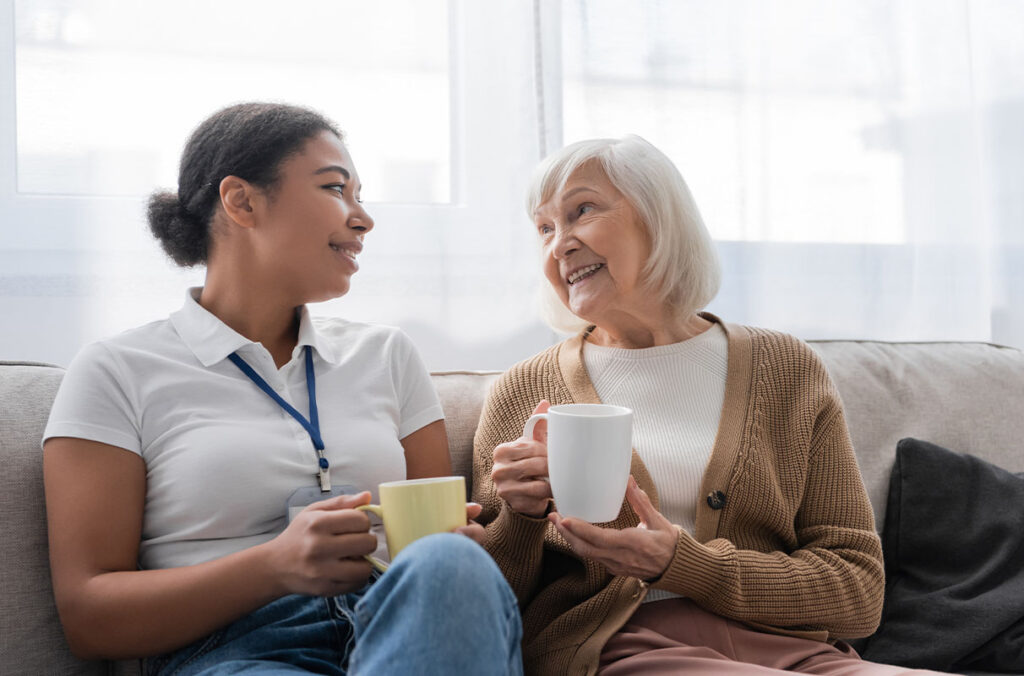Closeup of two women, one older and one younger, talking over coffee.