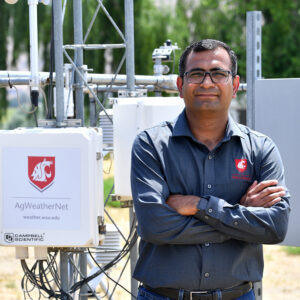 Closeup of Lav Khot standing next to a WSU AgWeatherNet station.