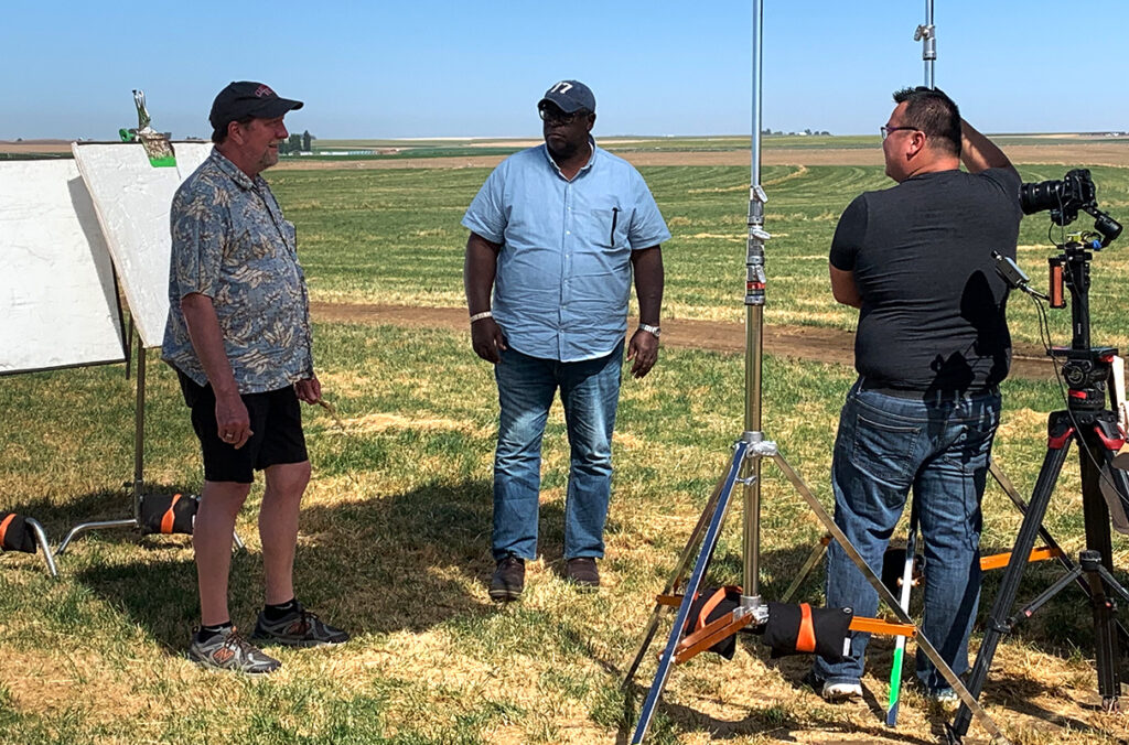 Michael Neff talking with "Ask This Old House" co-host Lee Gilliam during filming at a grass seed field in Washington.