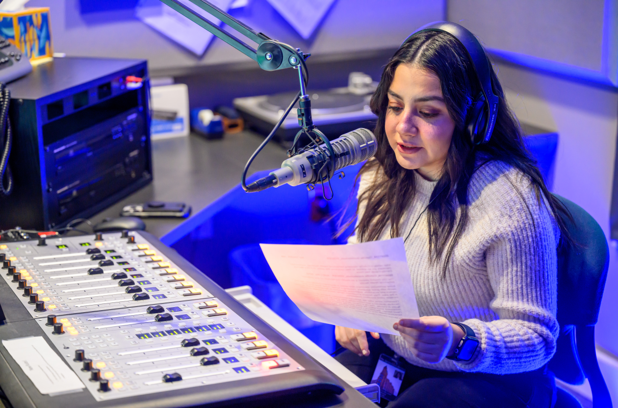 Murrow fellow Monica Carrillo-Casas reading a script into a microphone