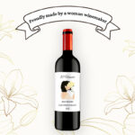 Composite featuring a "Proudly made by a woman winemaker" banner above a bottle of red wine against a floral background.