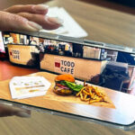 A smartphone app displays food at a restaurant.