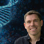 A composite featuring a closeup of Sascha Duttke and DNA strands in the background.