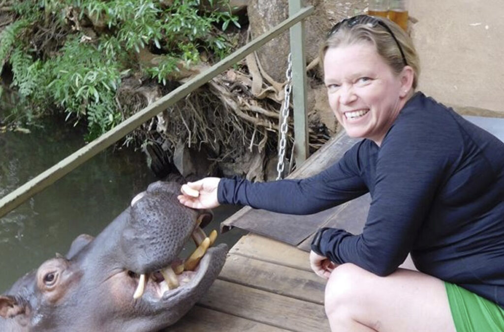 Closeup of Kimberly Ange-van Heugten feeding a hippo.