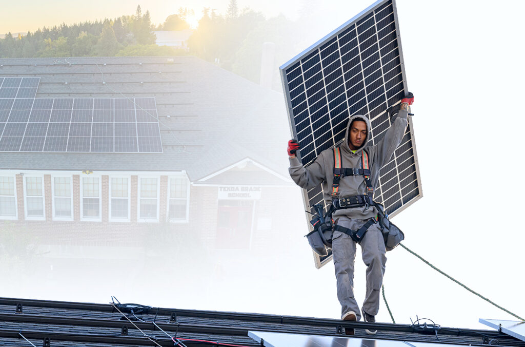 A composite featuring a man carrying a large solar panel across a roof during installation, and an aerial view of solar panels on the roof of Tekoa Grade School.