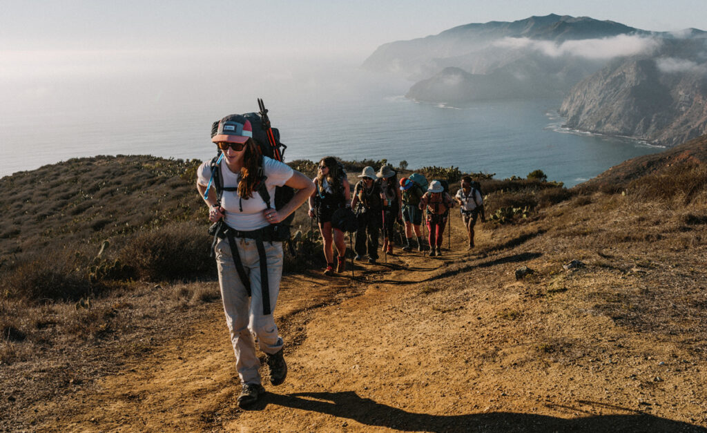 Ella Spillane leads a group of women up a hill on Catalina Island.