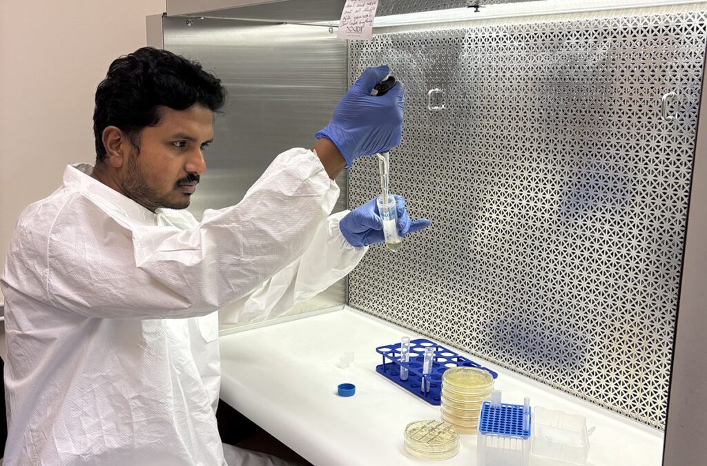 A scientist works with DNA samples in a lab.