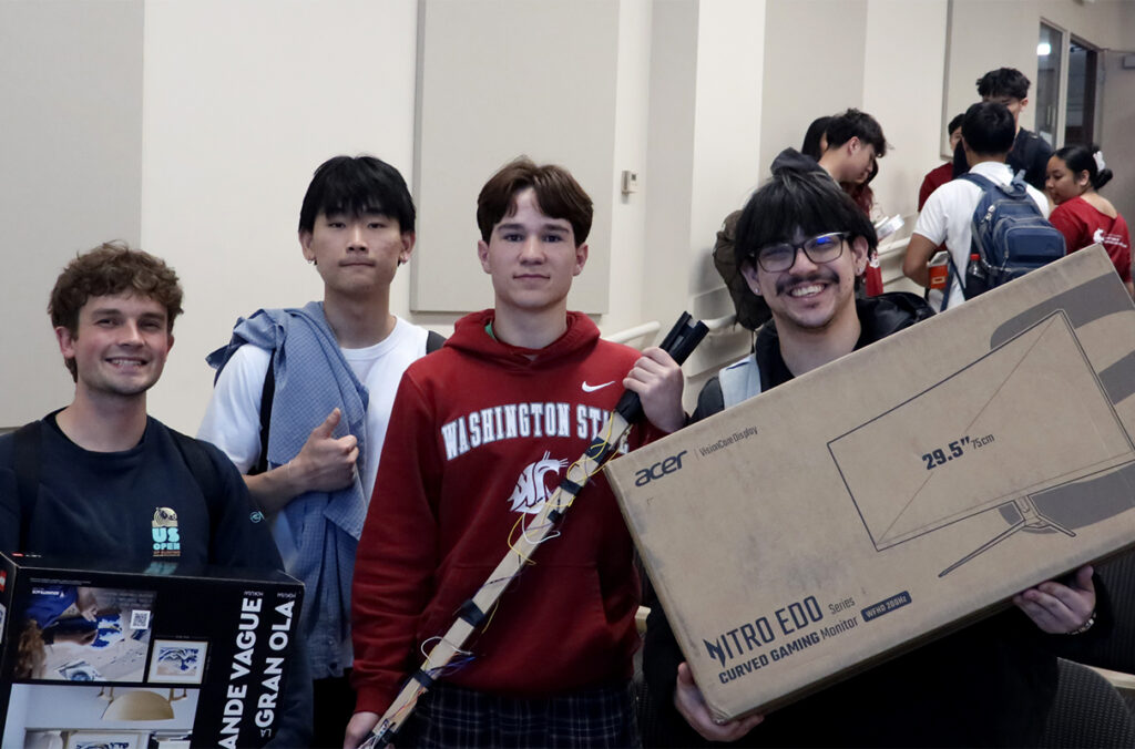 Four hackathon winners posing for a group photo.