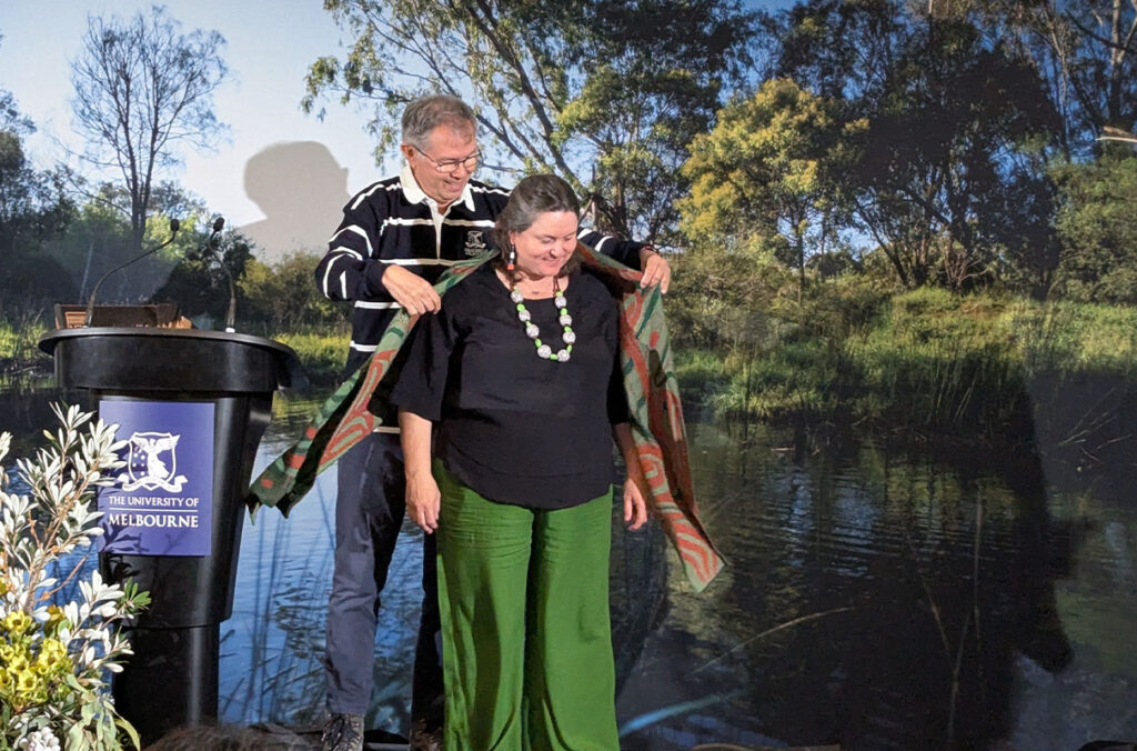Joe Gladstone presents a gift to Michelle Evans in Melbourne, Australia.