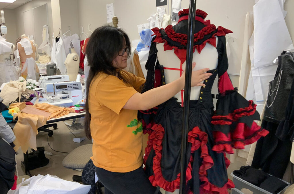 Britney Nguyen can be seen working on a design for the AMDT Fashion Show.
