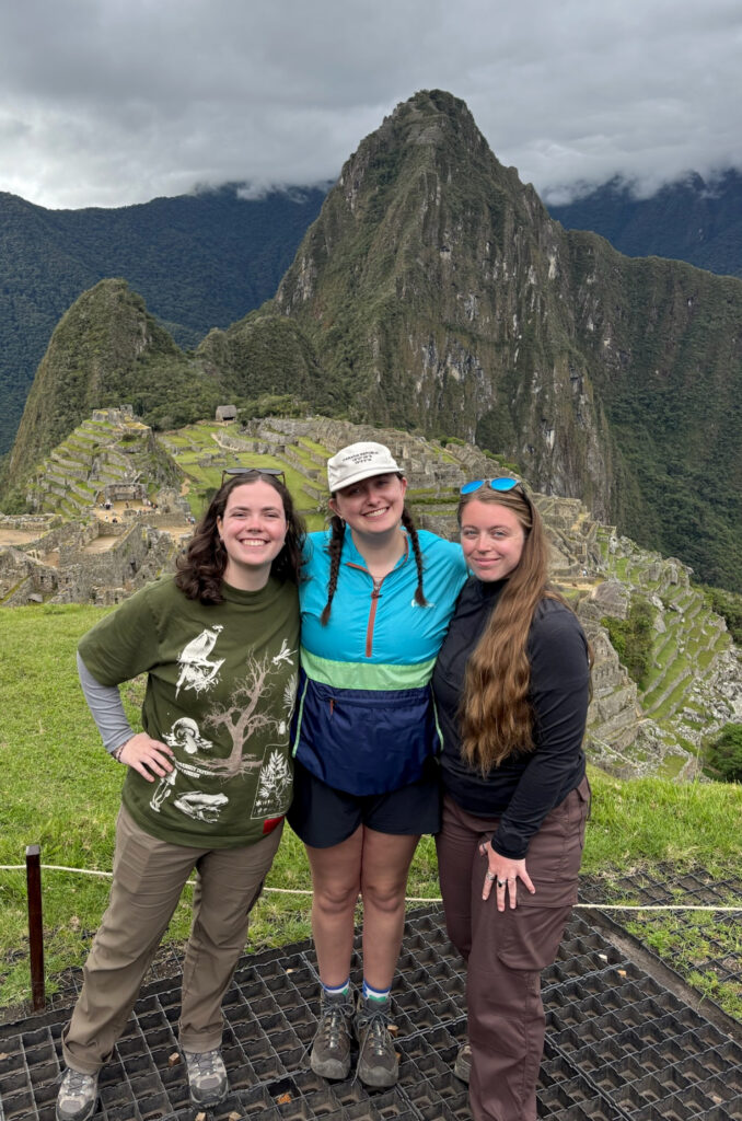 Three WSU students standing above the ancient ruins of Machu Picchu in Peru's Andes Mountains.