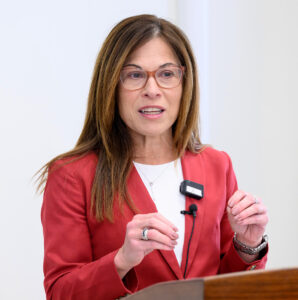 Closeup of Kim Christen standing at a podium.