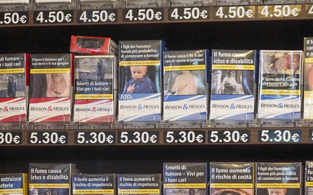 Packages of cigarettes with graphic health warnings are shown on a shelf in Italy.